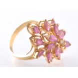 AN 18CT GOLD RUBY AND DIAMOND CLUSTER DRESS RING