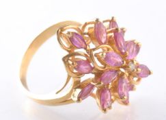 AN 18CT GOLD RUBY AND DIAMOND CLUSTER DRESS RING