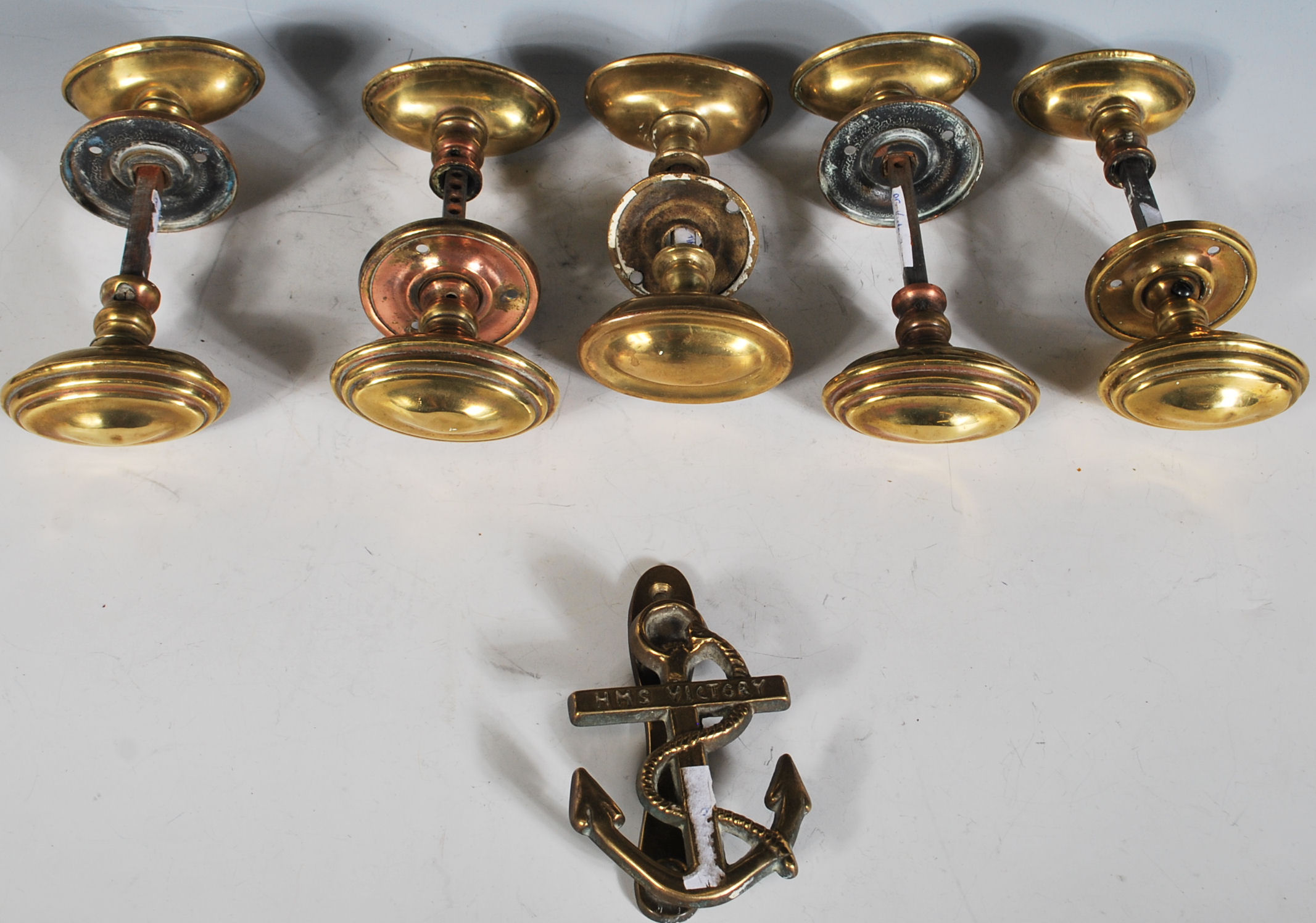 A group of five pairs of 19th Century Victorian brass door handles of oval stepped form. Each pair