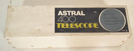 A boxed Astral 400 telescope finished in blue having retractable wooden tripod stand. Appears