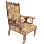 A Victorian 19th century mahogany library armchair. Raised on turned legs with castors having a
