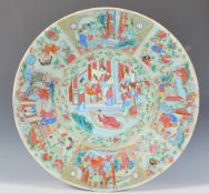 A 19th Century Chinese Canton famille verte wall charger plate having a round central panel hand