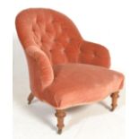 An early 20th Century walnut framed nursing / bed room armchair having a spoon button back,