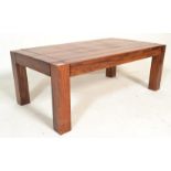 A 20th Century Indian Sheesham wood table of rectangular form being raised on block legs, the top