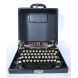 A vintage early 20th Century Remington portable typewriter with original fitted carry case dating to