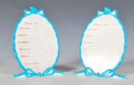 A pair of early 20th Century French porcelain table menus / place settings, of oval form having hand