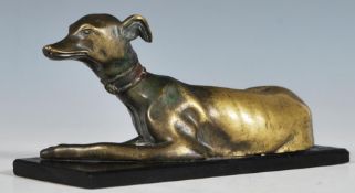 A late 19th Century Victorian  bronze sculpture model of a recumbent greyhound dog looking alert,