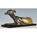 A late 19th Century Victorian  bronze sculpture model of a recumbent greyhound dog looking alert,