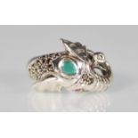 A silver and marcasite ring in the form of an elephants head set with an emerald cabochon and having