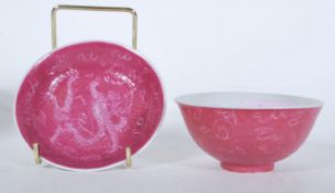 A 19th Century Chinese porcelain bowl having a pink ground with engraved Chinese dragon decoration