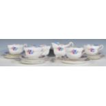 A vintage 20th Century part tea service by Paragon consisting of four cup, saucers and side