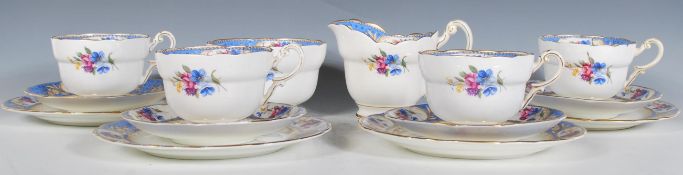 A vintage 20th Century part tea service by Paragon consisting of four cup, saucers and side