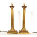 A pair of 20th Century antique style brass table lamp bases in the form of corinthian columns having