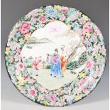 A 19th Century Chinese centrepiece plate having a central panel decorated with a hand painted