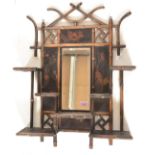 An early 20th century bamboo ebonised Aesthetic movement wall mirror having bamboo column supports