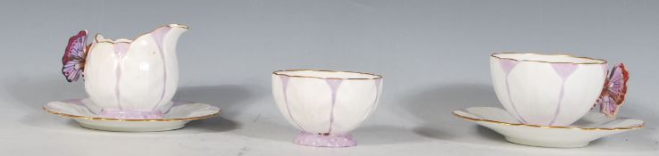 An Aynsley purple butterfly handle and leaf moulded part tea service compressing of one tea cup