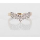 A stamped 375 9ct yellow gold wishbone ring having an illusion mount set with diamonds of approx
