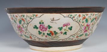 A large 19th Century Chinese crackle glazed pedestal punch bowl decorated with peony and bird in