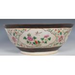 A large 19th Century Chinese crackle glazed pedestal punch bowl decorated with peony and bird in
