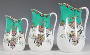 A set of three 19th Century Victorian era graduating ceramic water jugs having transfer printed