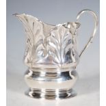 An Edwardian silver hallmarked creamer jug with acanthus leaf decoration pressed in relief having