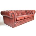 A good 20th Century Victorian style deep-buttoned back three seater Chesterfield sofa with red