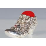 A Victorian style silver pin cushion in the form of a ladies shoe having floral decoration set