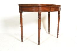 An 18th century Georgian mahogany tea / card games table raised on squared legs with fold over table