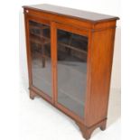 A 19th Century Victorian mahogany library bookcase cabinet having twin full length glazed panel