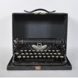 A Vintage early 20th Century Underwood Standard Portable Typewriter with fitted travel case. Glass