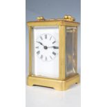 A 19th Century antique brass cased carriage clock raised on a plinth base with reeded supports,