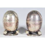 A pair of vintage 20th Century silver plate salt and pepper condiments of egg shape form raised on