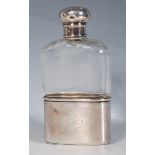 A Late Victorian / Edwardian faceted cut glass and silver hallmarked hip flask having a screw bun