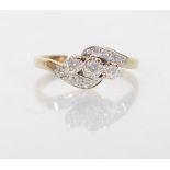 A stamped 375 9ct yellow gold ladies crossover ring set with three central round cut diamonds,