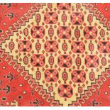 A 20th Century Moroccan North African floor rug of small proportions having a red ground with a