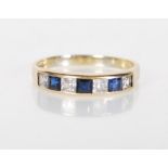 An English hallmarked 9ct yellow ladies ring set with white and blue square cut stones. Hallmarks