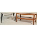 A mid century teak wood rectangular coffee occasional / table being raised on tapering legs being