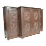 A 19th Century Jacobean revival oak breakfront sideboard / credenza, flared top over carved