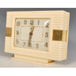 An early 20th Century French bakelite Art Deco mantel clock raised on a stepped base, gilt Arabic