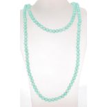 A 20th Century vintage jade style green stone long beaded necklace having a spring ring clasp.