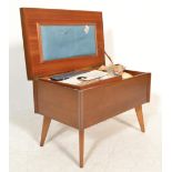 A vintage retro 20th Century teak sewing box raised on tapering legs with a flared hinged lid