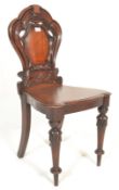 A 19th Century Victorian mahogany hall chair, circular back with a shield shaped motif splat,