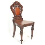 A 19th Century Victorian mahogany hall chair, circular back with a shield shaped motif splat,