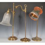 A group of three 20th Century antique style brass table lamps to include two tubular lamps raised on