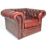 A 20th century Oxblood leather chesterfield armchair. The arm with button backing to the leather