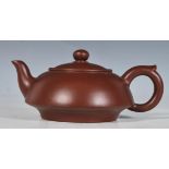 A 20th Century Chinese ceramic brown clay teapot of small proportions having character marks to