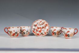 A set of four 20th Century Japanese Kutani export ware porcelain tea cups together with a saucer