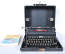 A vintage early 20th Century Royal Portable typewriter in fitted carry case, glass keys with Royal