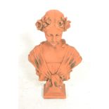 A 19th century Victorian terracotta bust of a classical maiden lady being raised on a socle plinth