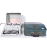 A vintage Hermes Media 3 Swiss made 20th Century portable typewriter in case, together with a faux